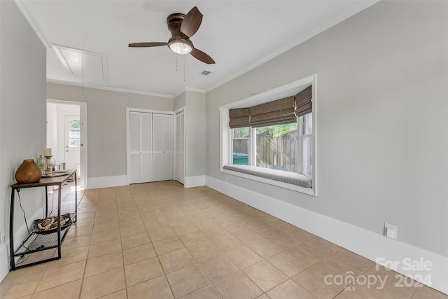 spare room with light tile patterned flooring and ornamental molding