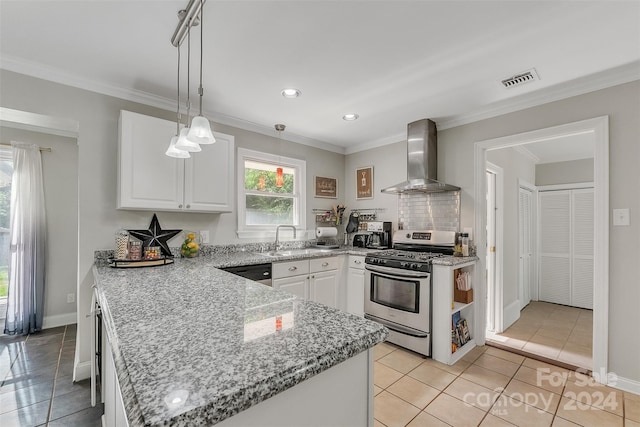 kitchen with white cabinetry, hanging light fixtures, stainless steel range with gas stovetop, light tile patterned flooring, and wall chimney exhaust hood