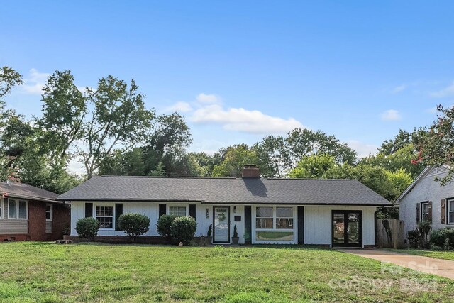 ranch-style home with a front lawn