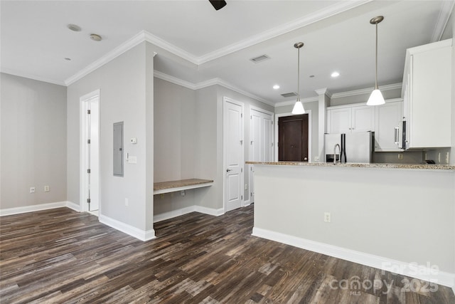 kitchen featuring dark hardwood / wood-style floors, crown molding, white cabinetry, and stainless steel appliances