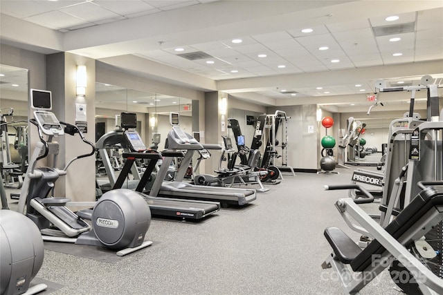 exercise room with a paneled ceiling