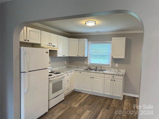 kitchen with white appliances, arched walkways, dark wood finished floors, ornamental molding, and a sink