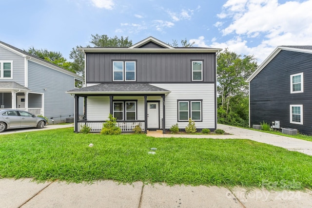 front of property featuring a porch, central air condition unit, and a front lawn