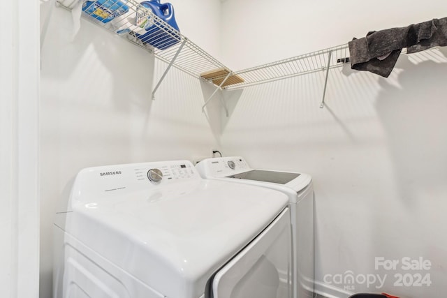 clothes washing area with washer and dryer