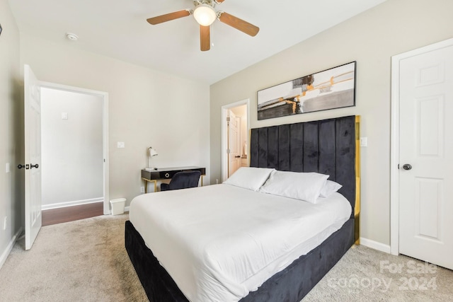 bedroom with ceiling fan and light colored carpet