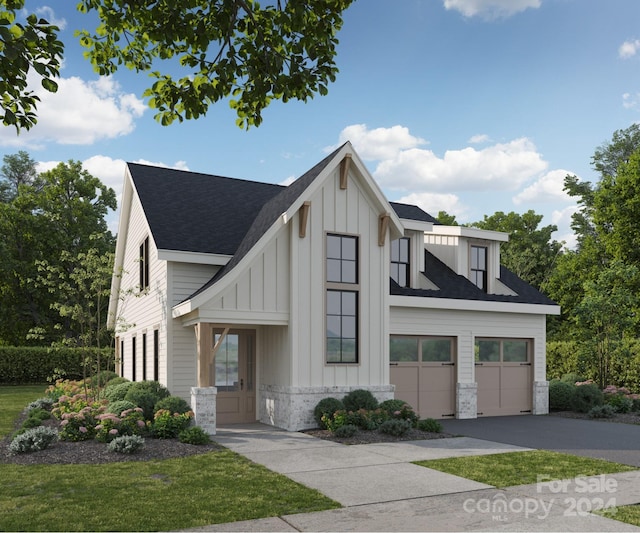 view of front of home with a garage and a front lawn