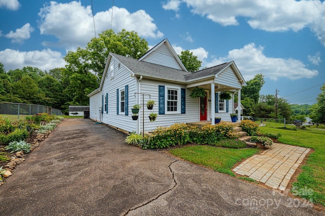 view of front of property with a porch and a front lawn