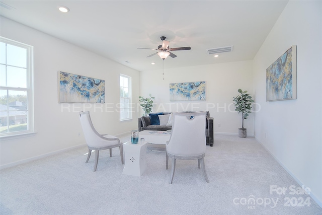 carpeted dining space featuring ceiling fan