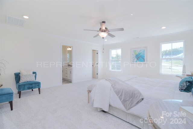 carpeted bedroom with connected bathroom, ceiling fan, and crown molding