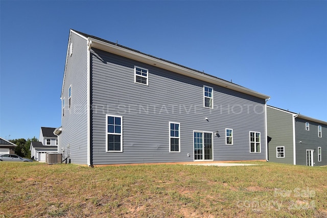 back of property with a lawn and cooling unit