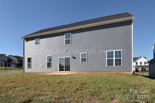 back of property featuring a yard and a patio