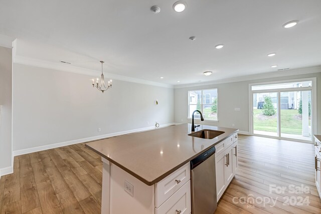 kitchen with a center island with sink, light hardwood / wood-style floors, stainless steel dishwasher, sink, and white cabinets