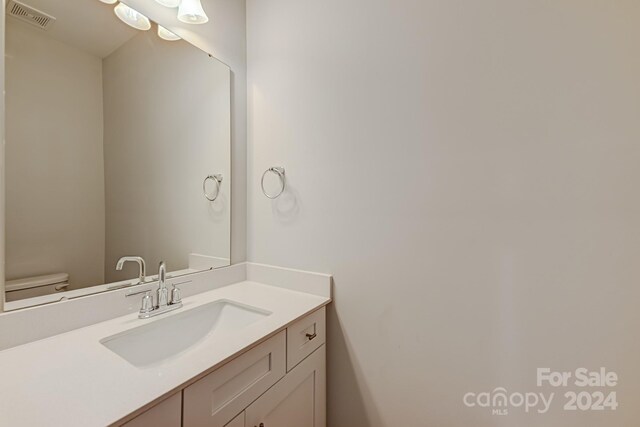 bathroom featuring toilet and vanity