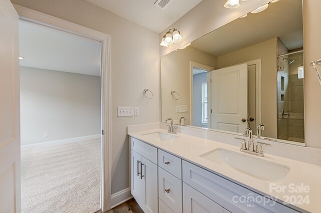 bathroom with vanity and a shower with shower door