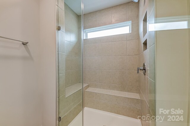 bathroom featuring a shower with shower door