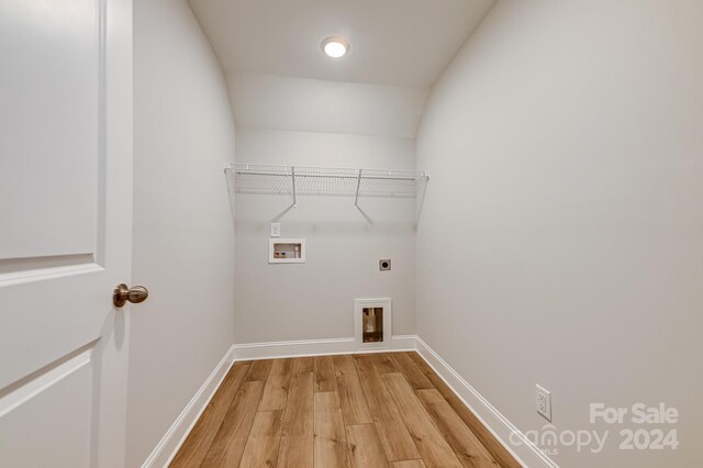 washroom with light wood-type flooring, hookup for a washing machine, and electric dryer hookup