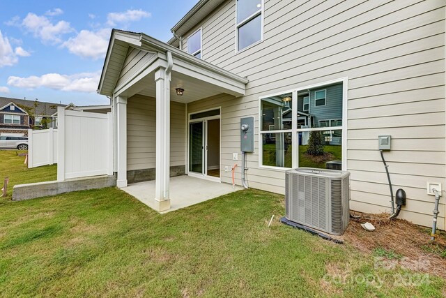 back of house featuring a yard, a patio, and central air condition unit