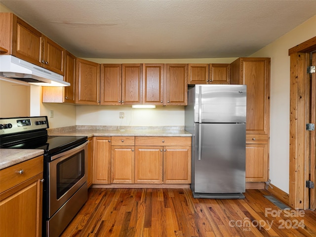 kitchen with dark hardwood / wood-style floors and stainless steel appliances