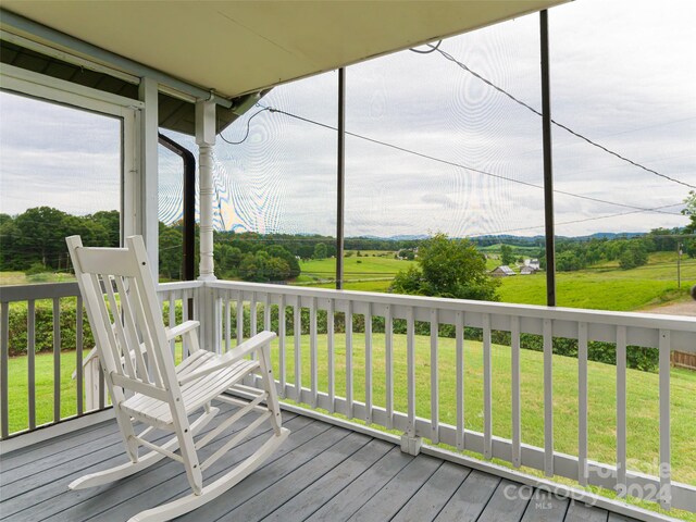 wooden terrace featuring a yard