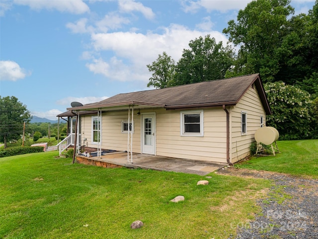 view of front of property with a patio area and a front yard