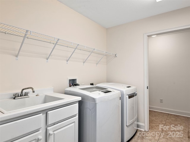 laundry area with washer and dryer, tile patterned floors, cabinets, and sink