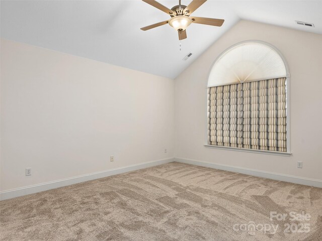 spare room with carpet, ceiling fan, and lofted ceiling