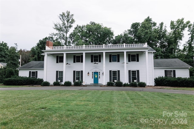 neoclassical home with a front lawn