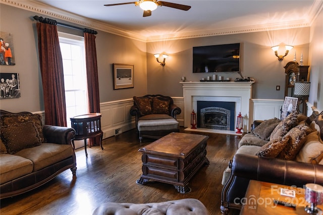 living room with ornamental molding, dark hardwood / wood-style flooring, and ceiling fan