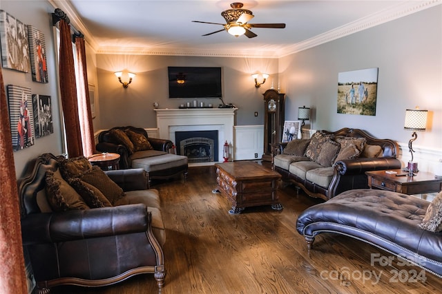 living room with dark hardwood / wood-style floors, crown molding, and ceiling fan