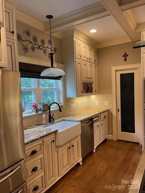 kitchen featuring appliances with stainless steel finishes, light stone counters, decorative light fixtures, backsplash, and dark hardwood / wood-style flooring