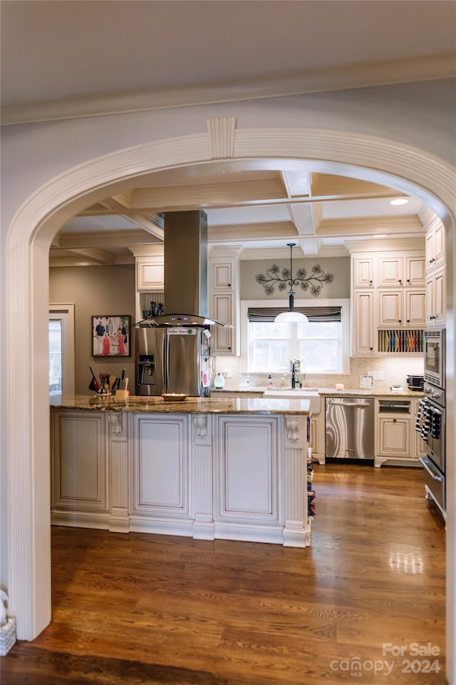 kitchen featuring backsplash, stainless steel appliances, coffered ceiling, wood-type flooring, and island range hood