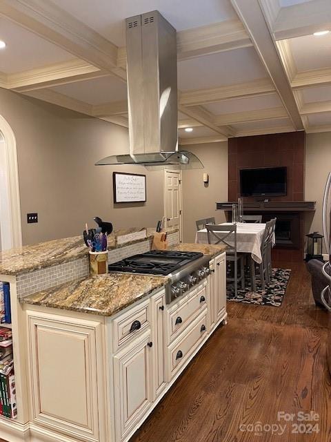 kitchen with stainless steel gas stovetop, dark hardwood / wood-style floors, light stone countertops, range hood, and coffered ceiling