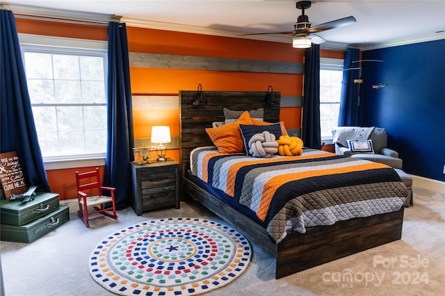 bedroom featuring crown molding, multiple windows, ceiling fan, and carpet flooring