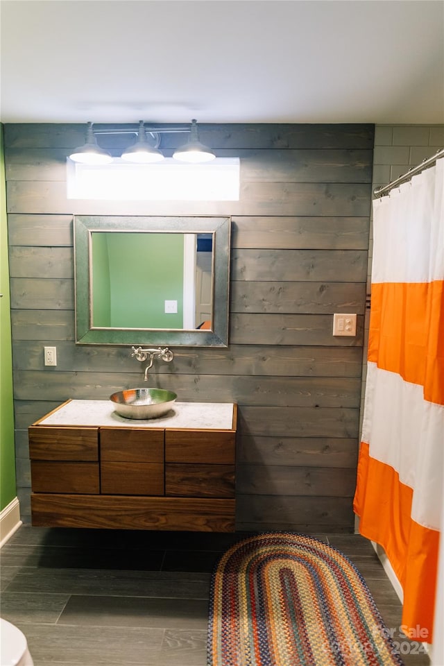 bathroom featuring wood walls and vanity