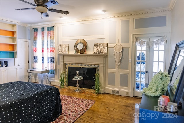 bedroom with crown molding, ceiling fan, and hardwood / wood-style floors