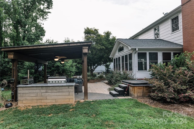 view of yard with a patio, a sunroom, and ceiling fan