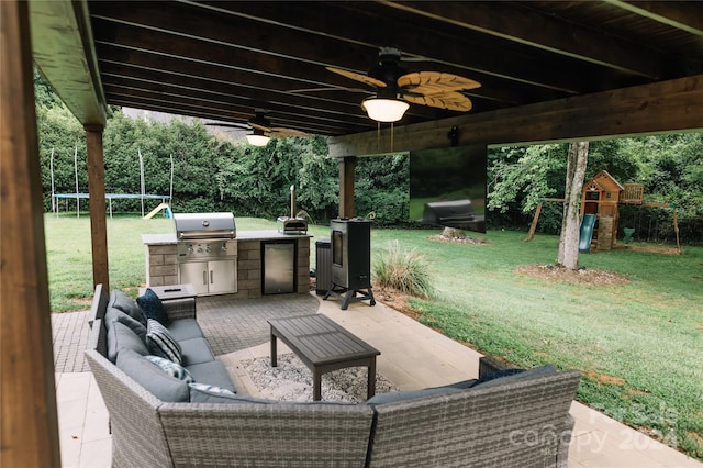 view of patio featuring a playground, outdoor lounge area, ceiling fan, and grilling area