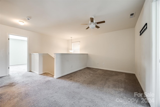 empty room with ceiling fan and carpet floors