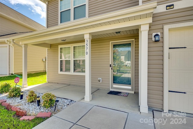 view of exterior entry with a porch