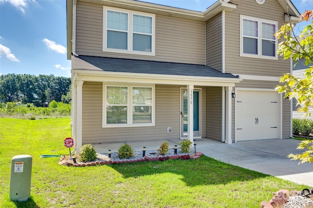 view of front of house with a garage, a front yard, and a porch