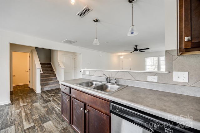 kitchen featuring pendant lighting, sink, dishwasher, dark brown cabinets, and dark hardwood / wood-style flooring