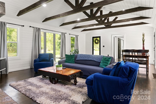 living room featuring dark wood-type flooring, wooden walls, and lofted ceiling with beams