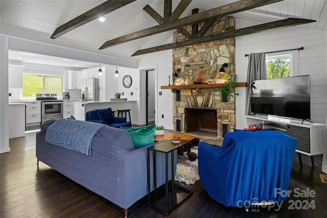 living room with dark hardwood / wood-style floors, a stone fireplace, and vaulted ceiling with beams