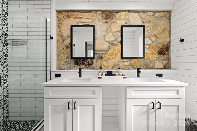 bathroom featuring vanity and tiled shower