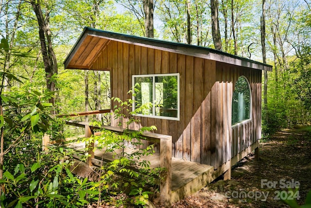 view of property exterior with an outdoor structure