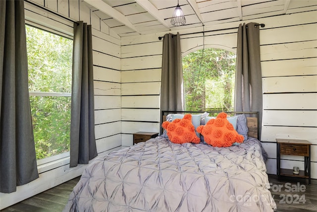 bedroom featuring dark hardwood / wood-style floors and wood walls