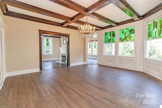 interior space featuring beamed ceiling, dark hardwood / wood-style floors, a notable chandelier, crown molding, and coffered ceiling