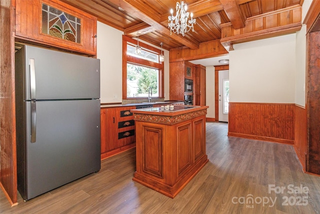 kitchen featuring black appliances, wood ceiling, a kitchen island, dark wood-type flooring, and hanging light fixtures