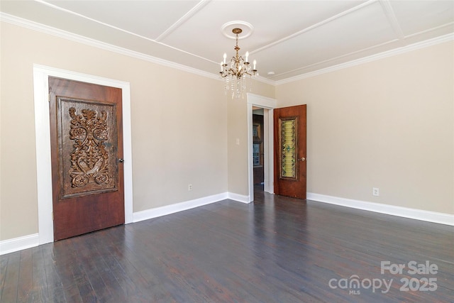 empty room featuring a chandelier, crown molding, and dark hardwood / wood-style floors