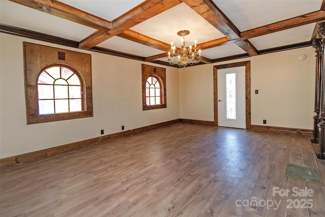 unfurnished room featuring coffered ceiling, beamed ceiling, hardwood / wood-style floors, and an inviting chandelier